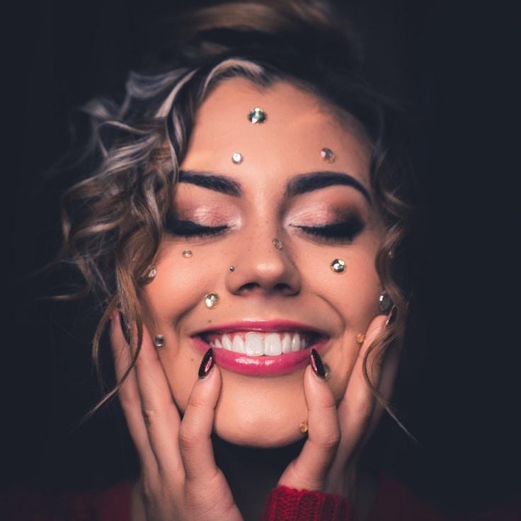 Kaveri Mehta, Lead Design Curator at OrchardPixelLight, reviewing corporate floral arrangements